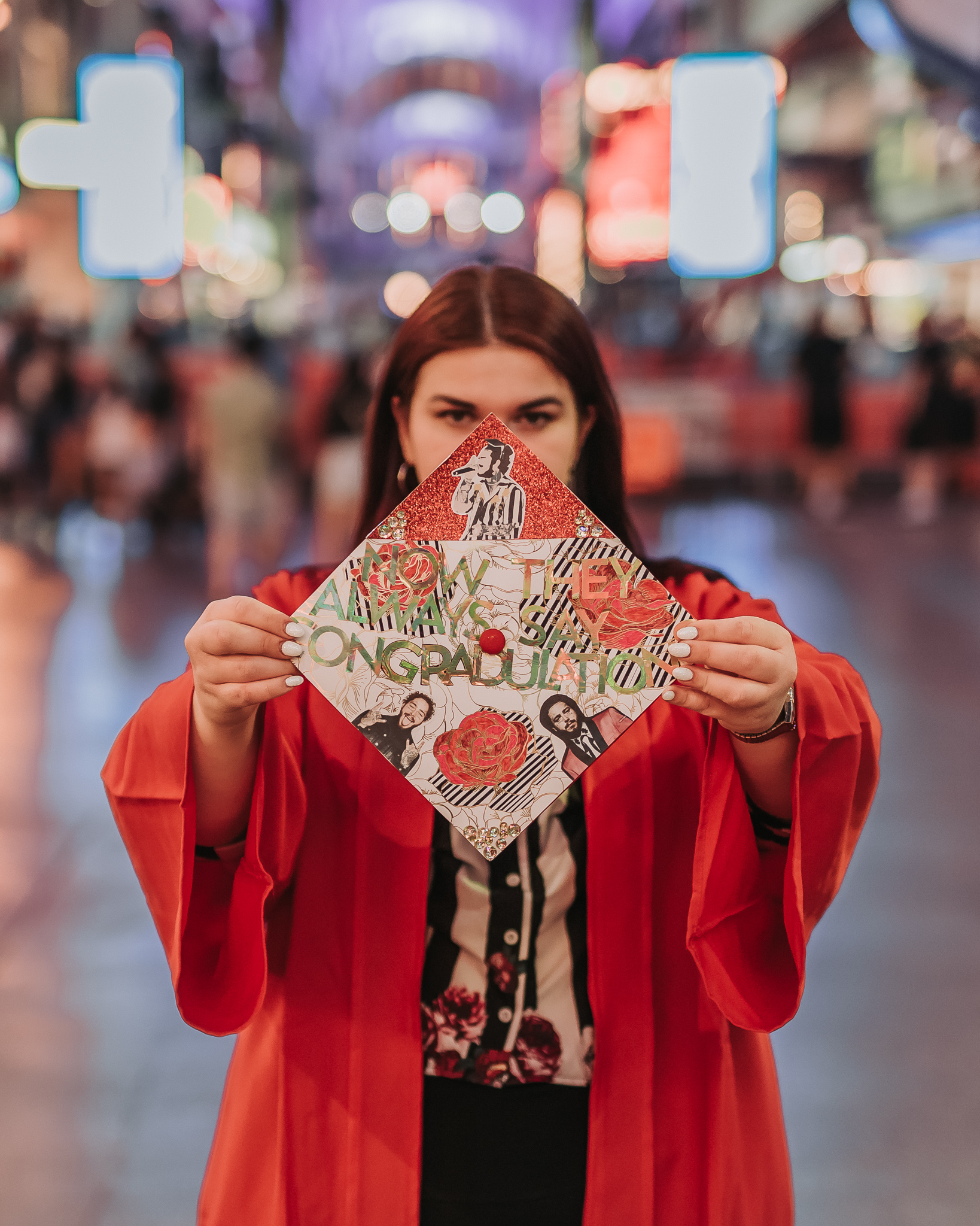 girl with decorated graduation cap and red robe