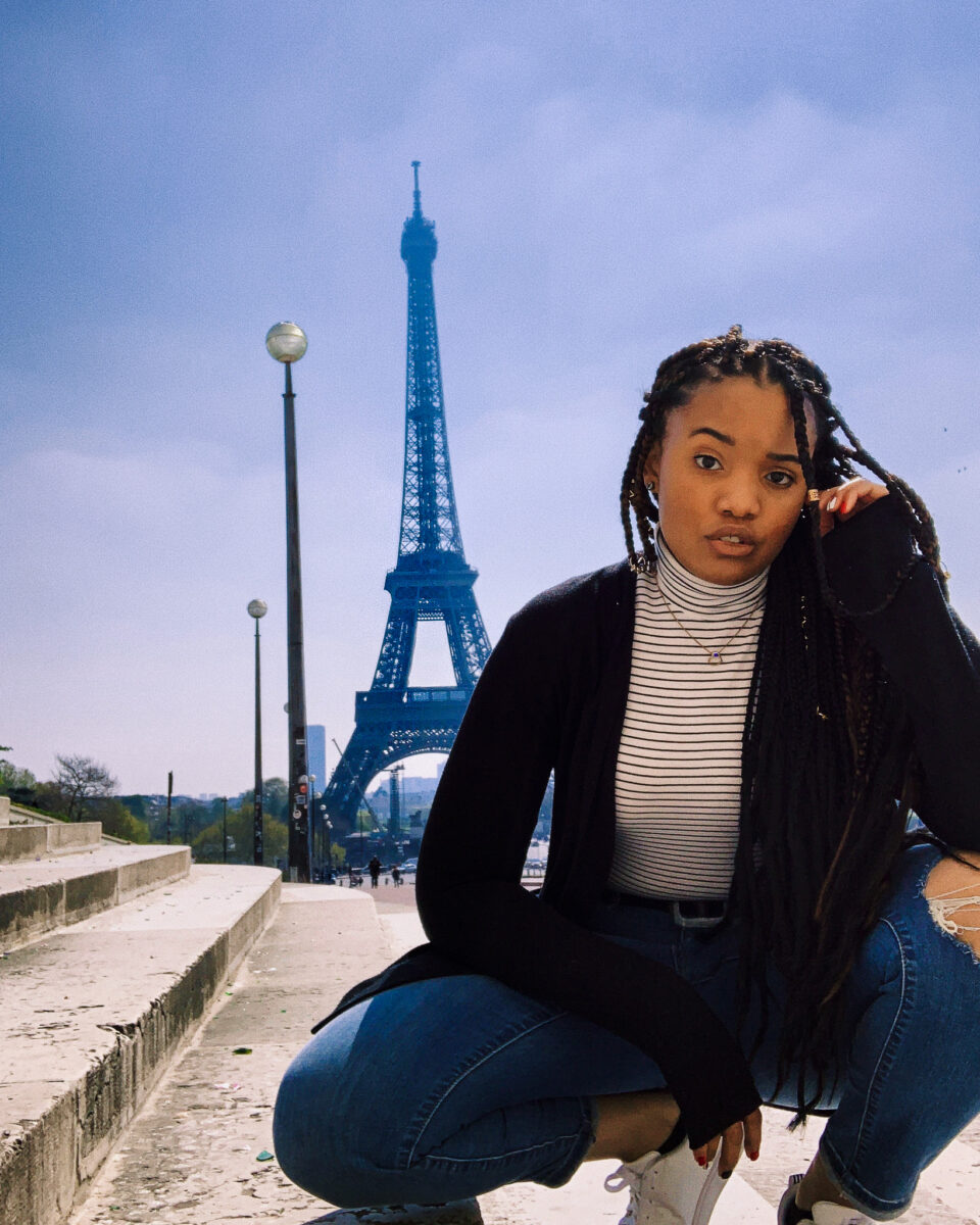 black girl in front of Eiffel Tower