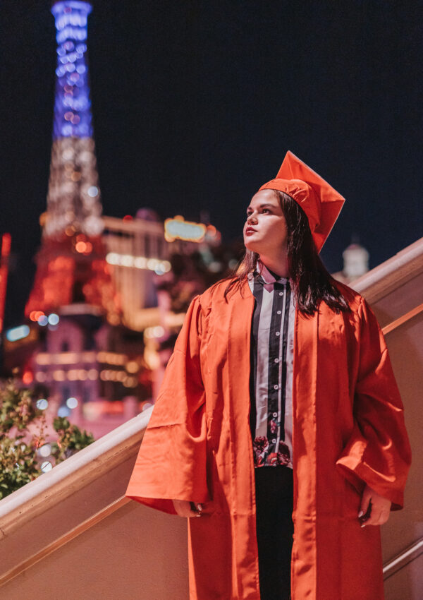 girl in red graduation cap and gown Las Vegas strip Paris hotel and casino