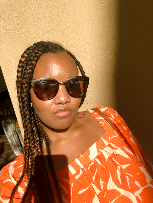 selfie of black girl with braids and glasses